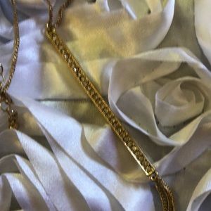 Gold necklace with diamond bar/ tassels.